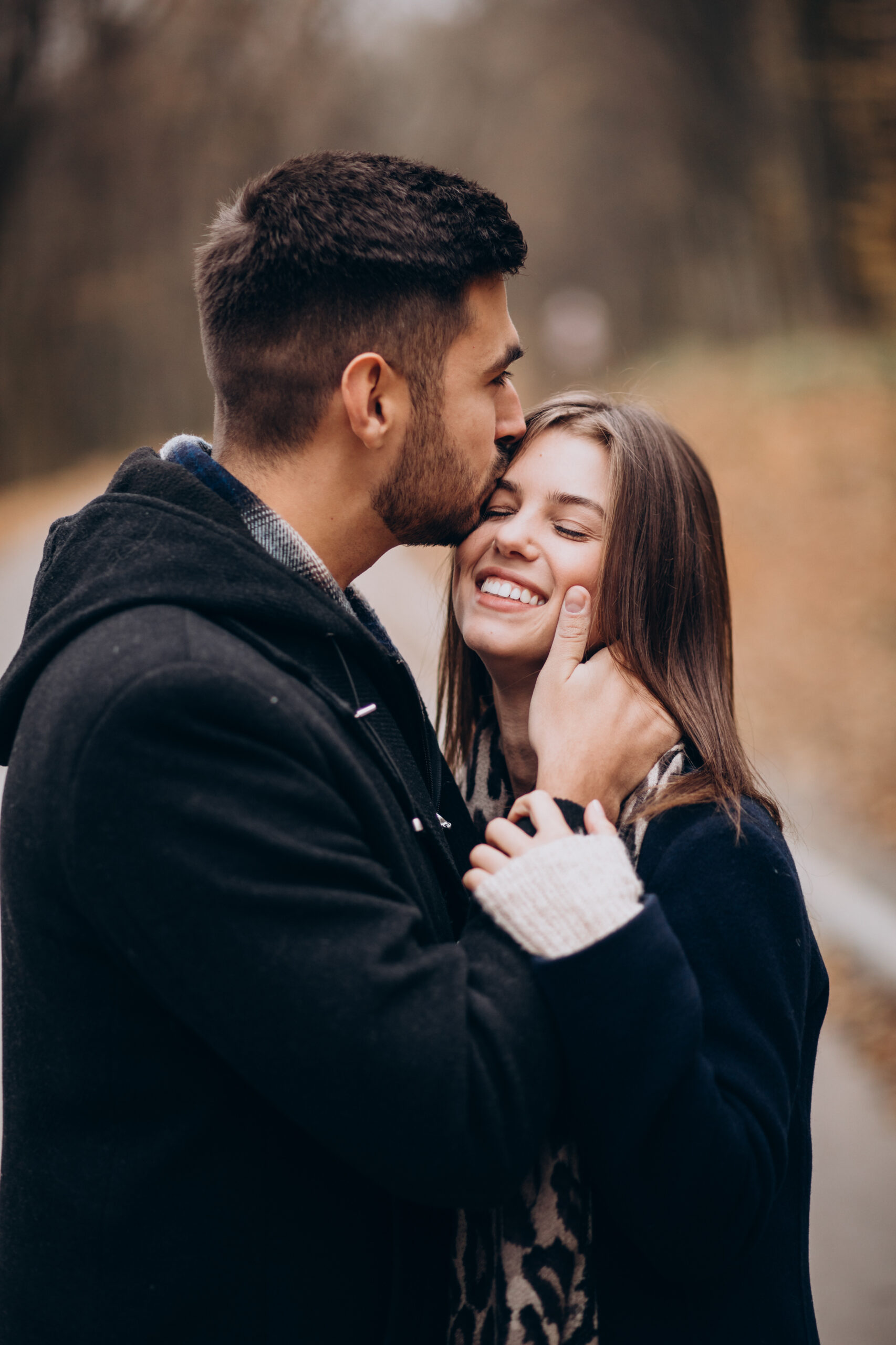 young couple together walking in an autumn park